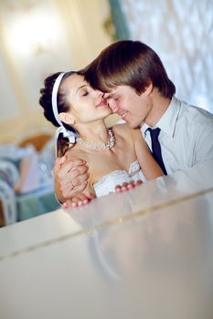 happy bride and groom at the piano