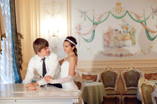 happy bride and groom near the piano