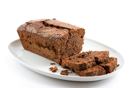 chocolate cake on a plate with two slices separately cut