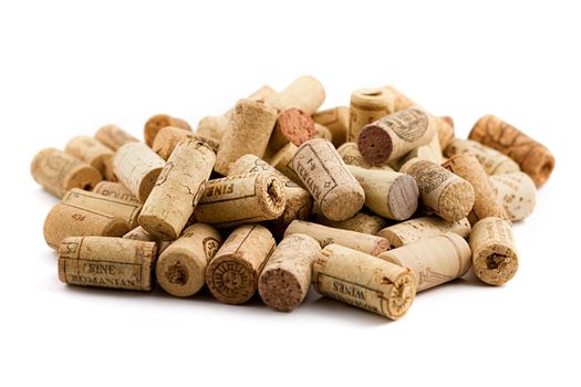 bunch of wine corks scattered on white background