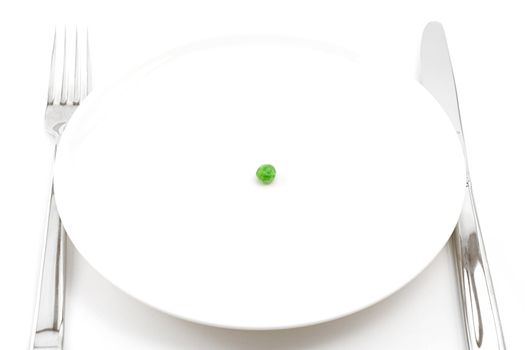 single pea on a plate, knfie, fork, shot on white