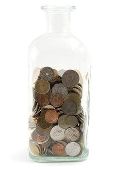 jar filled with coins, shot on white