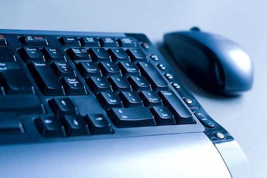 mouse and keyboard, slanted shot, blue tone, shallow DOF