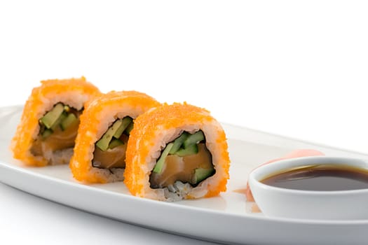 sushi rolls served on a plate with soy sauce, shot on white