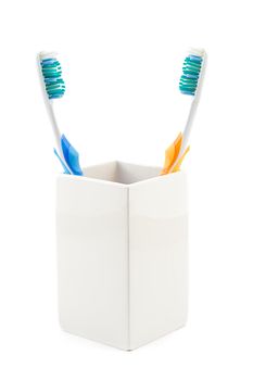 toothbrushes in cup, shot on white