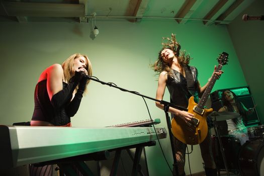 Caucasian girl band playing instruments.