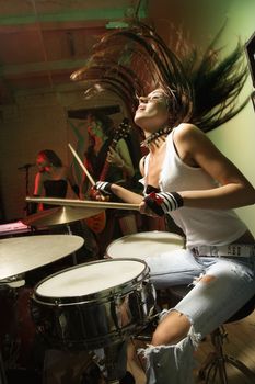 Caucasian girl band playing instruments.