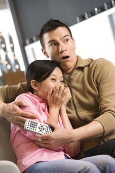 Asian female with scared expression while Asian male comforts her.