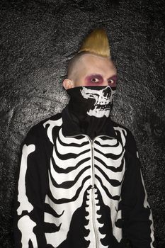 Mid-adult Caucasian male punk wearing skeleton sweatshirt and skeleton bandanna.