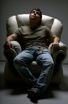 relaxed young man in white chair