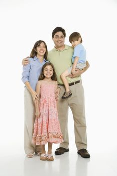 Hispanic family standing against white background.