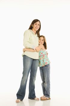 Full length portrait of mother and daughter standing hugging.