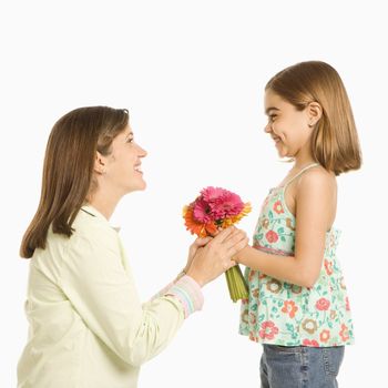 Girl giving bouquet of flowers to mother.