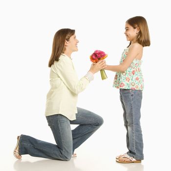 Daughter giving bouquet of flowers to mother.