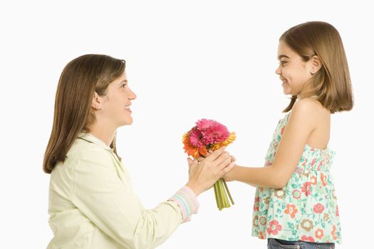 Girl giving mother bouquet of flowers.