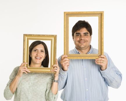 Man and woman looking through empty frames.