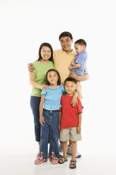Asian parents with three children standing in front of white background.
