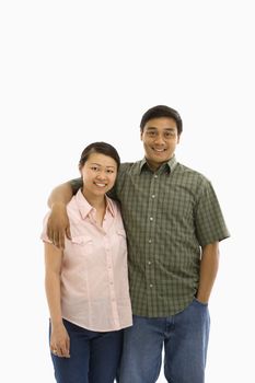 Asian man and woman standing with arms around eachother.