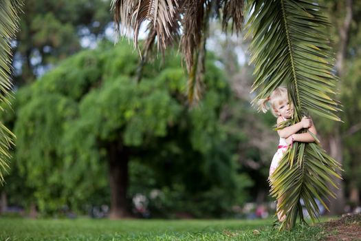 small girl with a palm leaf