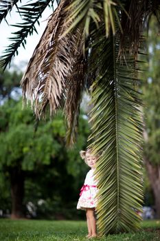 small girl with a palm leaf
