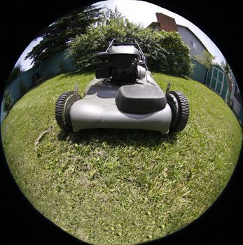 Lawnmower in the backyard through fish eye