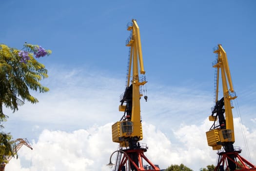 two hoisting cranes and the sky