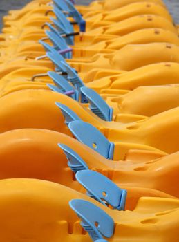 Pedal boats lining up in a row