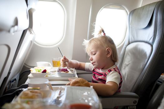 child eating in the airplane