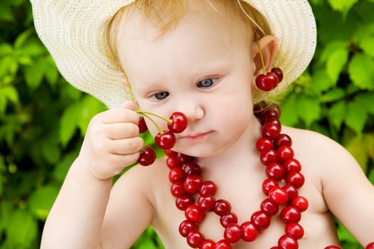 small girl with red cherry beads and earings