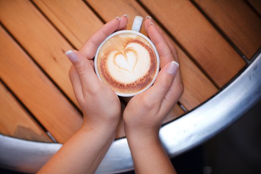 two hands and cup of coffee