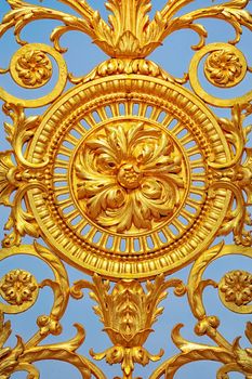 Detail of golden door of Versailles Palace. France