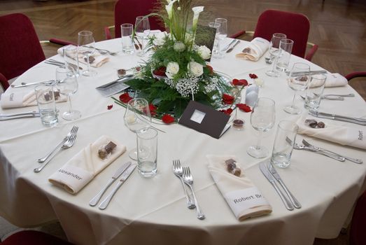 a beautiful festive banquet with dishes, wineglasses and place cards