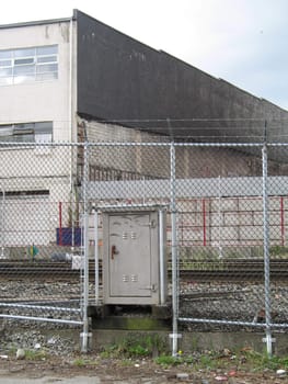 industrial building behind a fence