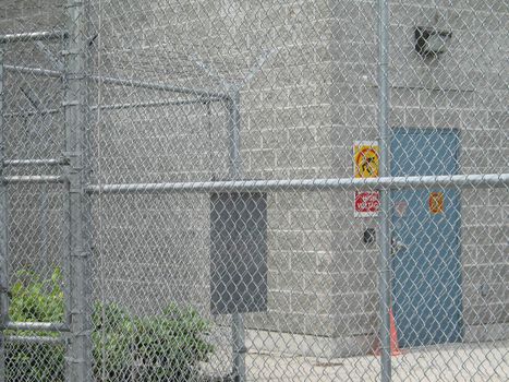 industrial building behind a fence