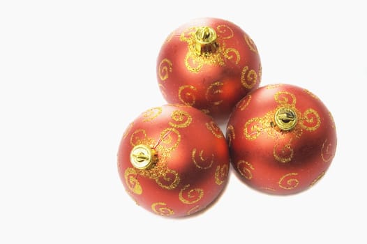 Three red christmas balls on a white background