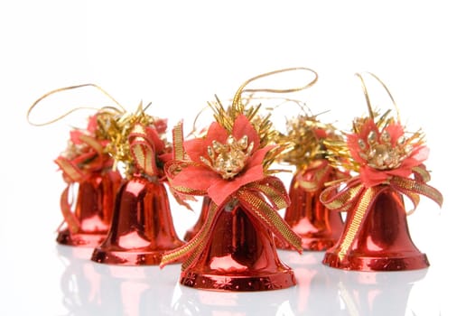 Many red christmas handbells on white background