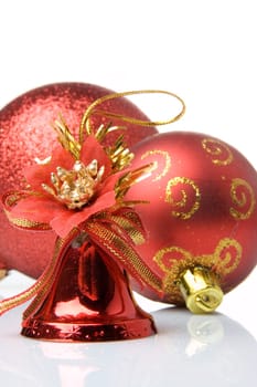 Red christmas balls and handbells on a white background