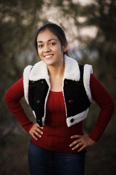 Portrait of pretty Hispanic teenager in outdoor setting