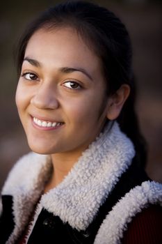 Portrait of pretty Hispanic teenager in outdoor setting