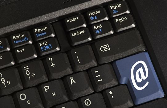 Closeup of a keyboard, stating @ for email