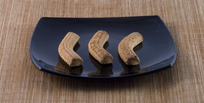 Three Italian typical biscuits on a black plate