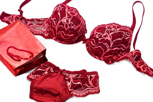 red lace silky lingerie near red present box over white