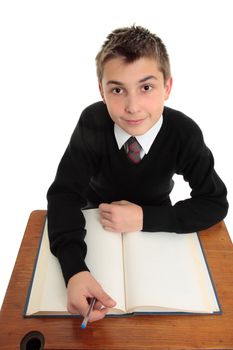 Young high school student looking up with open book at desk.