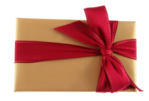 A Christmas present wrapped in gold paper with red ribbon.