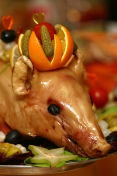  It is baked a pig decorated with fruit and vegetables