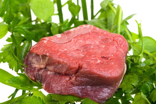 raw fillet steak on mixed herbs