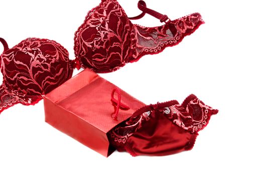 red lace silky lingerie near red present box over white