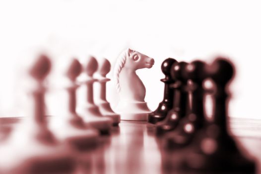 knight on chess board between pawns in line