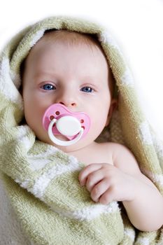 Baby girl covered by towel