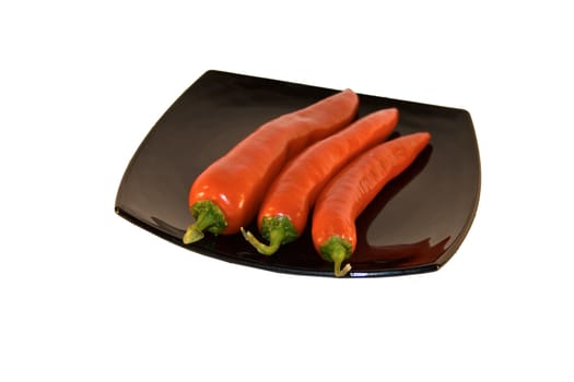 group of red chili on black plate